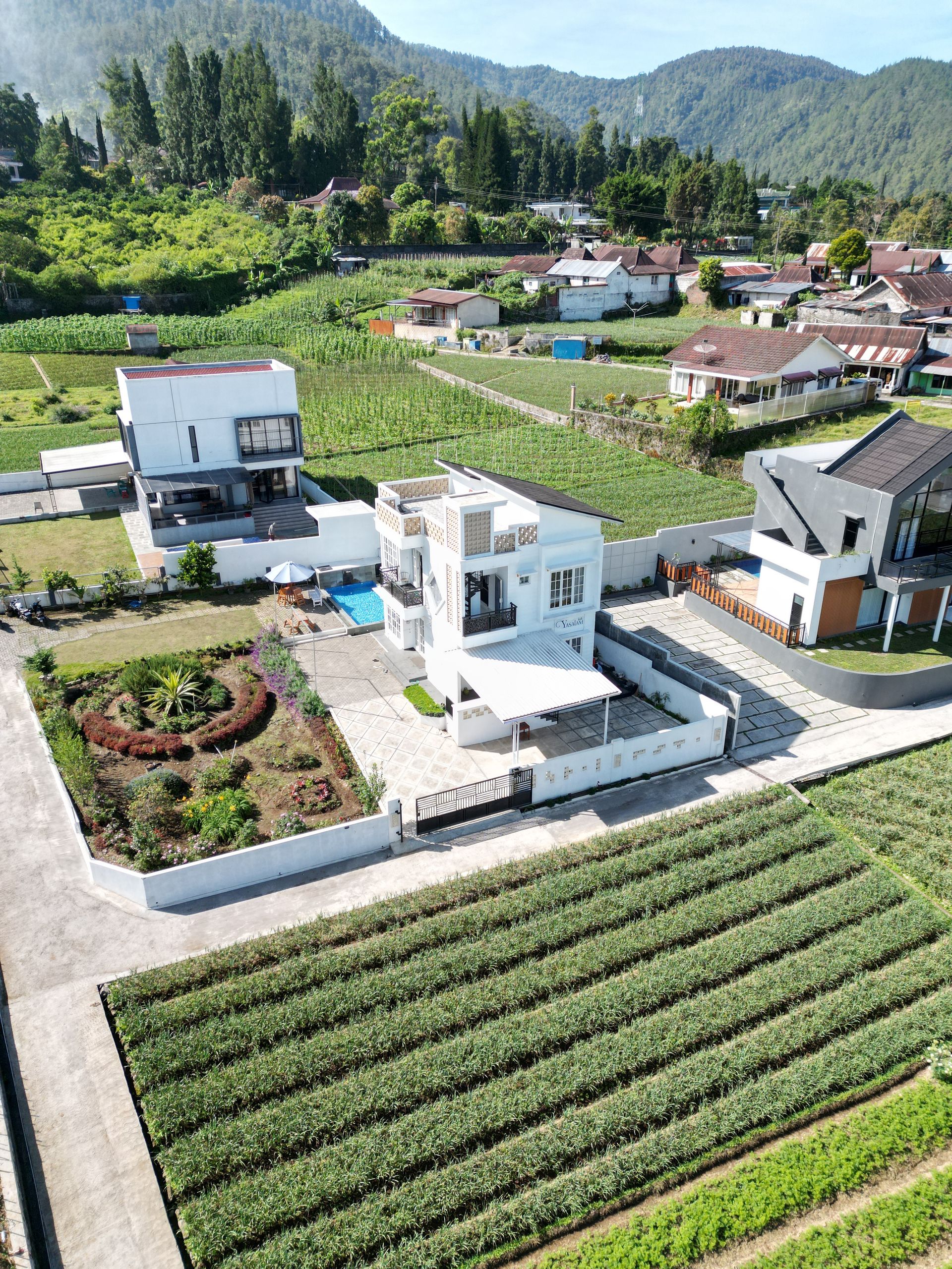 Aerial view of modern farmhouse and fields