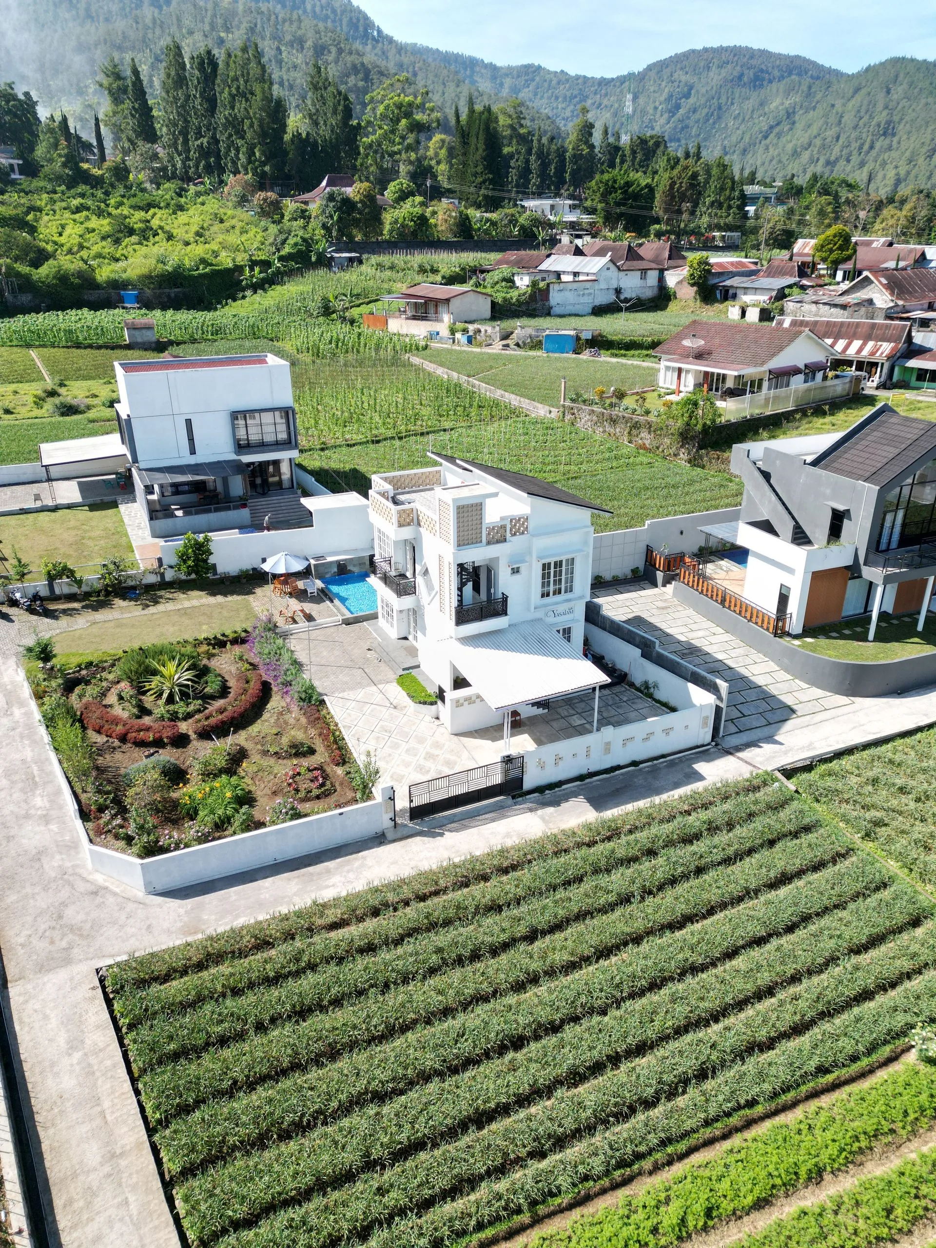Aerial view of modern farmhouse and fields